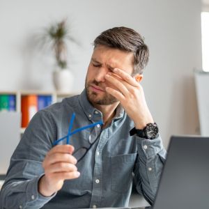 Person experiencing dry eye symptoms, including gritty, watery, and irritated eyes - Eye Max Centre